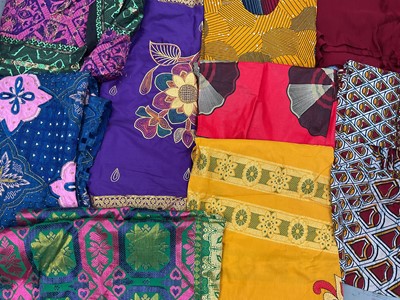 Lot 521 - Collection of mostly African and Indian fabrics including bright designs, beadwork, a throw and a paisley pattern bead spread (3 boxes)