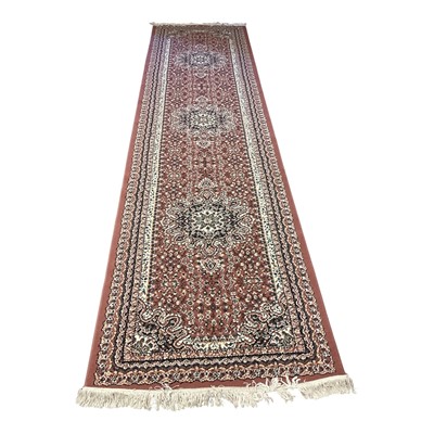 Lot 1435 - Eastern runner with three central medallions on dark pink, cream and blue ground, 302cm x 90cm