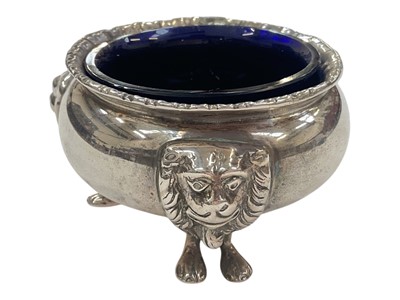 Lot 977 - Edwardian silver salt with three lion mask and paw feet and a blue glass liner