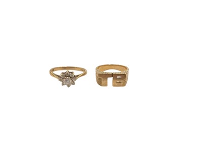 Lot 1032 - 9ct gold synthetic white stone flower head dress ring and one other 9ct gold initial ring (2)
