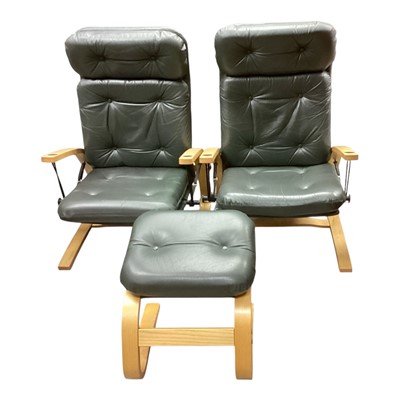 Lot 1477 - Pair of contemporary reclining chairs and a matching footstool (3)