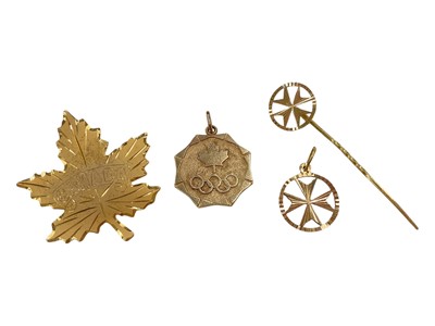 Lot 1040 - 10k gold Canada Olympics pendant, yellow metal Canada maple leaf brooch, together with a yellow metal Maltese cross pendant and stick pin, both marked 'C.18'