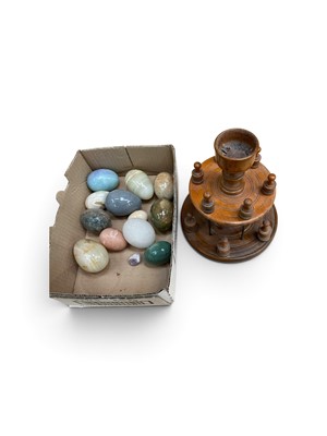 Lot 224 - 19th century turned treen cotton reel holder, together with a collection of polished hardstone eggs