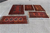 Lot 1512 - Pakistan rug with segmented field on brick-red...