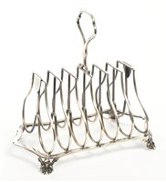 Lot 250 - Edwardian silver six-division toast rack of...