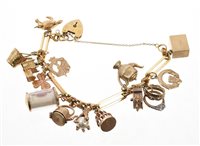 Lot 538 - 9ct gold charm bracelet with a collection of...