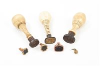 Lot 670 - Three George III ivory-handled desk seals,...