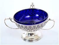 Lot 386 - George V silver three-handled bonbon dish of...