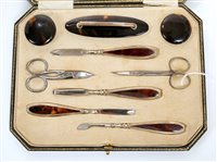 Lot 389 - 1920s silver and tortoiseshell nine piece...