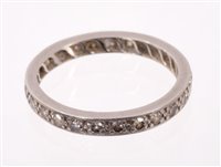Lot 570 - Diamond eternity ring with a full band of...