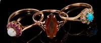 Lot 406 - Three gold and gem set dress rings to include...