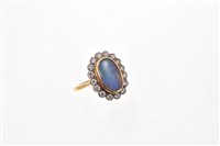 Lot 517 - Opal and diamond cluster ring with an oval...