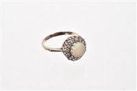 Lot 522 - Opal and diamond cluster ring with a round...