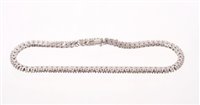 Lot 528 - Diamond tennis bracelet with a line of 77...