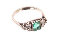 Lot 531 - Emerald and diamond ring with a step cut...
