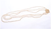 Lot 534 - Cultured pearl three-strand necklace with a...