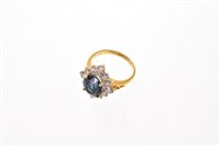Lot 519 - Sapphire and diamond cluster ring with an oval...