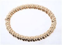 Lot 491 - 9ct gold hinged bangle with spiral twist...