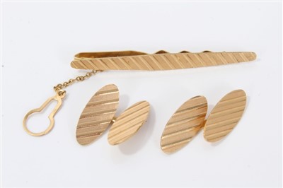Lot 3242 - Gold (stamped 750) tie clip and pair matching oval cufflinks