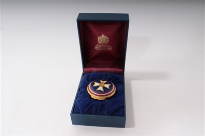 Lot 42 - The Royal Victorian Order – Halcyon Days circular enamel box with Royal Victorian Order badge