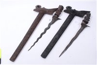 Lot 833 - Two Malayan Kris Daggers in ornately carved wood scabbards with figural grips, one with a watered steel blade, together with a Kukri in leather sheath (3)