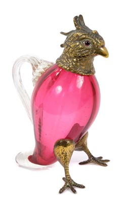 Lot 905 - Victorian cranberry glass spirit/oil decanter in the form of bird with brass mounts