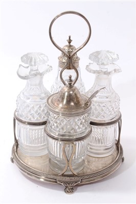 Lot 386 - George III silver cruet frame with four lidded cut glass condiment bottles, William Bateman 1819