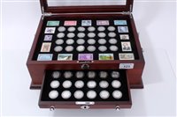 Lot 123 - U.S. a teak two-drawer cabinet with glass hinged top, containing ‘The Last U.S. Silver Dimes’ (x 48), with Certificates of Authenticity (48 coin set)