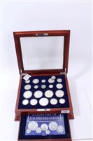 Lot 126 - U.S. a teak one-drawer cabinet with glass hinged top, containing ‘A Century of U.S. Silver Coin Collection’, with Certificates of Authenticity (qty)