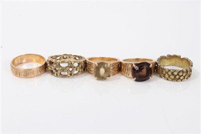 Lot 3246 - Group five 1970s yellow metal textured design rings, two set with gem stones