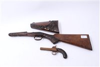 Lot 910 - 19th century percussion pocket pistol and two 19th century Continental carved walnut gun stocks (3)