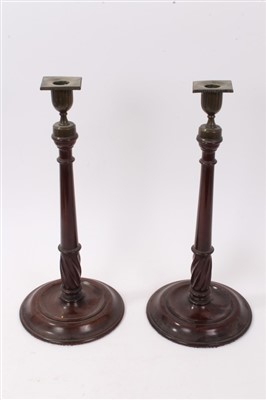 Lot 819 - Pair of George III mahogany and brass mounted candlesticks