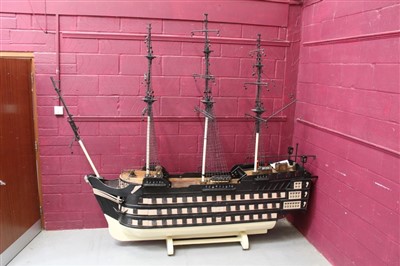 Lot 1070 - Very large and impressive old painted wooden model of HMS Victory with removable sides and opening stern