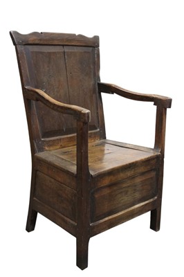 Lot 1433 - Mid-18th century Welsh oak commode chair, the panel back with undulating top rail and hinged solid seat on field panel frieze and square supports