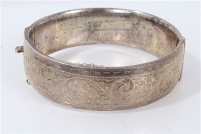 Lot 3337 - Silver bangle with engraved scroll decoration