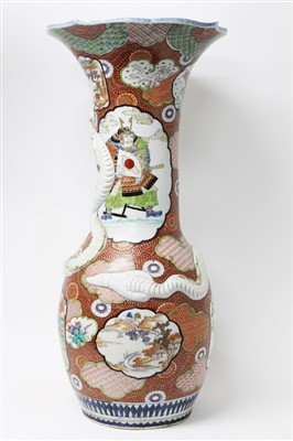Lot 2219 - Late 19th century Japanese porcelain floor vase with moulded coiled dragon and painted Samurai and floral reserves, on iron-red and gilt ground, 78cm