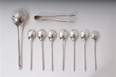 Lot 486 - Russian silver sugar nips, set of six Russian silver spoons, large Russian engraved spoon, small silver engraved spoon