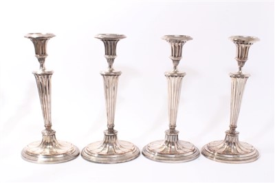 Lot 389 - Set of four early 19th century silver plated candlesticks with fluted tapering stems