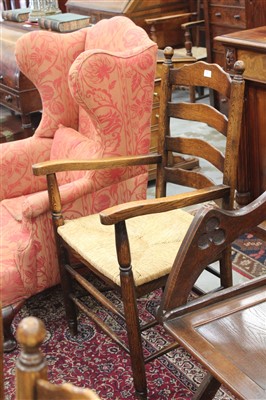 Lot 1489 - Set of eight oak ladderback chairs with rush seats, comprising two carvers and six standards