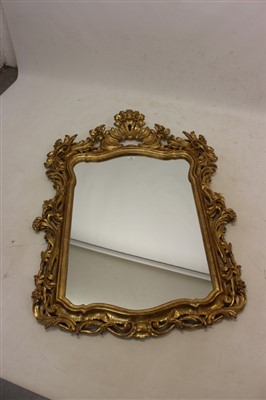 Lot 1384 - 18th century-style rococo giltwood and gesso wall mirror