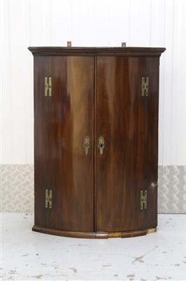 Lot 1394 - George III mahogany bow front hanging corner cupboard with painted interior enclosed by two doors with moulded cornice. 75cm wide