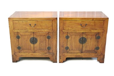 Lot 1396 - Pair of Chinese elm bedside tables with single drawer and cupboard below with brass handles, 63cm wide.