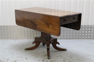 Lot 1399 - Regency mahogany Pembroke table with end drawer and opposing dummy drawer on square reel moulded column to the shaped platform with overscroll reeded quadruped supports on brass paw cappings 102cm