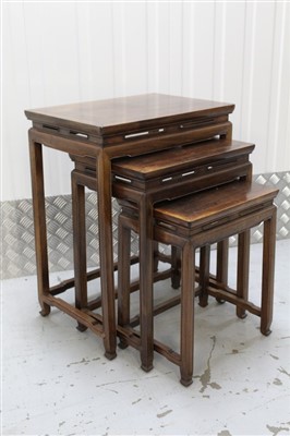 Lot 1406 - Nest of three Chinese hardwood occasional tables on square supports
