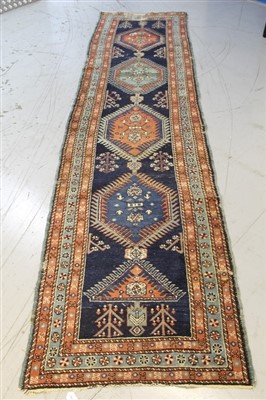 Lot 1414 - Eastern runner, with four serrated medallions on nasty blue ground in multiple borders, 350 x 90cm