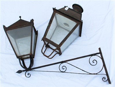 Lot 1433 - Antique painted metal street lamp, tapered form with glazed sides projecting on scrolling bracket, together with a similar lamp