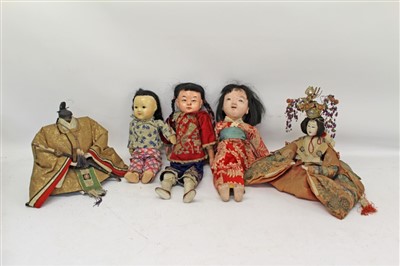Lot 41 - Late 19th/Early 20th century Japanese Empress and Emperor (head missing) plus three other Oriental dolls all in original clothing (5)