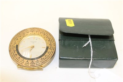 Lot 454 - Luxor eight day travelling alarm clock, with silvered dial gold coloured hands and hour markers, in a brass case with hinged stand and international time scale, together with an outer leather case.