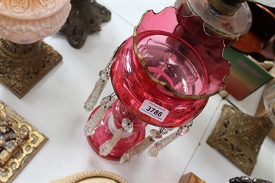 Lot 118 - 19th century ruby glass lustre, with crenellated rim and opaque spiral twist ornament, 55cm high