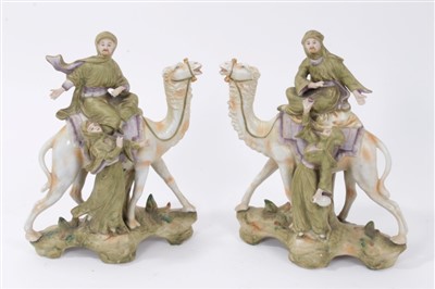 Lot 97 - A pair of Continental porcelain groups of camels and attendants